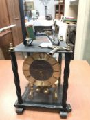 A metal cased anniversary clock with key
