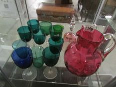 2 cranberry glass jugs,