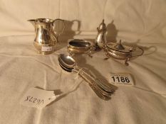 4 silver tea spoons, a silver cream jug, and a 3 piece silver condiment set,