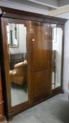 A mahogany wardrobe with mirrored doors