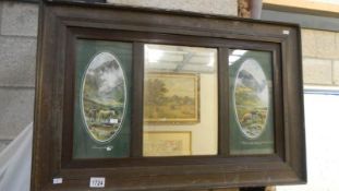 An Edwardian single framed bevel edged mirror with pictures one each side 'Leaving the Hills' and