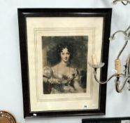 A framed and glazed portrait print of a young lady