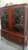 A Regency style mahogany glazed top bookcase on drawer base