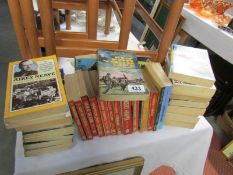 A large quantity of military related paperback books