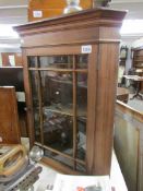 A mahogany glazed corner cupboard