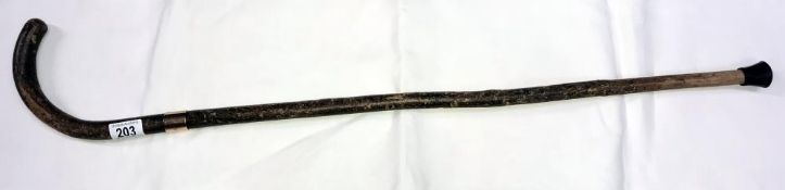 A walking stick with 9ct gold band