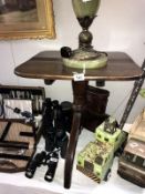 An oak tilt top tripod table