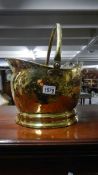 A polished brass coal scuttle