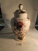 A Coalport jar and cover decorated with birds and flowers