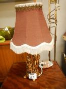 A figural table lamp with shade