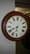 A circular mahogany wall clock