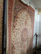 A beige ground Keshan carpet,