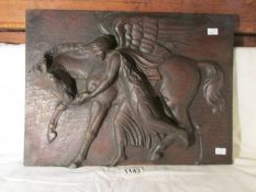 A wooden relief carving of Pegasus