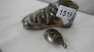 A silver coated 'First Shoe' (no hall mark but tests as silver) together with a white metal babies