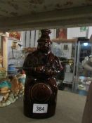 A pottery decanter in the shape of a man,