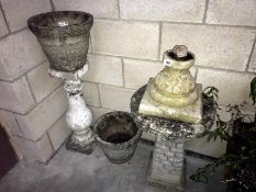 A bird bath and garden pots