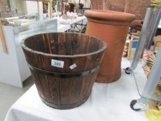 A wooden planter and a terracotta pot