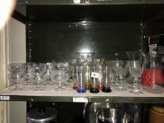 A shelf of assorted glass ware