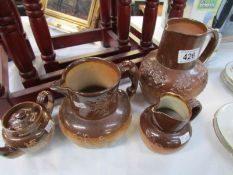 3 Doulton stoneware jugs and a teapot