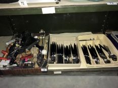 A shelf of assorted cutlery