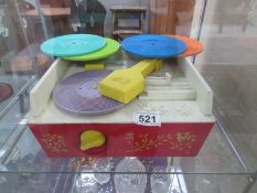 A Fisher Price record player with records