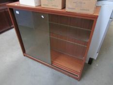 A glazed sliding door cabinet