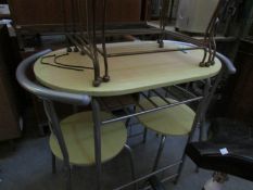 An oval kitchen table and 2 chairs