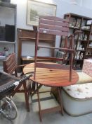 A wooden garden table and 2 chairs