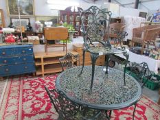 A metal garden table and 4 chairs