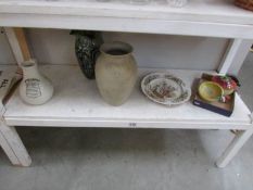 A shelf of ceramic vases etc