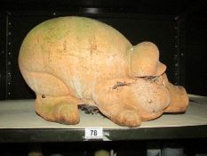 A large terracotta pig garden ornament