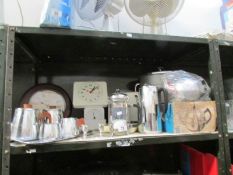 A shelf of kitchenware including stainless steel