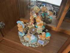 A Pendelfin stand and 5 Pendelfin figures