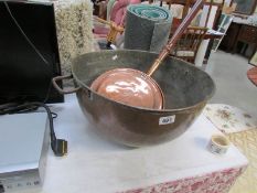 A large copper bowl and a copper warming pan