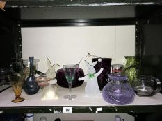 A shelf of assorted glass ware