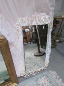 A wrought iron framed mirror