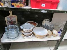 A shelf of kitchen ware including Pyrex