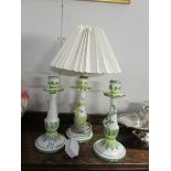 A table lamp and a pair of matching candlesticks