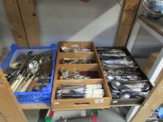 A large quantity of cutlery in 2 trays