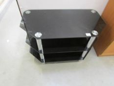 A black glass television stand