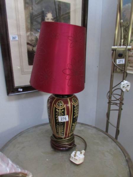 A ceramic table lamp with shade