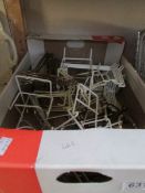 A box of plate stands etc
