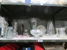 A shelf of assorted glass ware