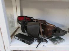 A quantity of camera's and binoculars