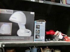 A shelf of hair driers and other hair appliances