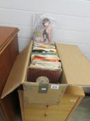 A box of assorted 45 rpm records including picture discs