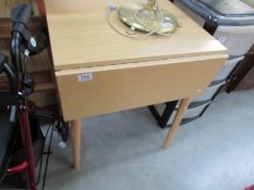 A formica topped drop leaf table