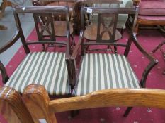 A pair of elbow chairs