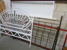 A metal bedstead and a cane headboard