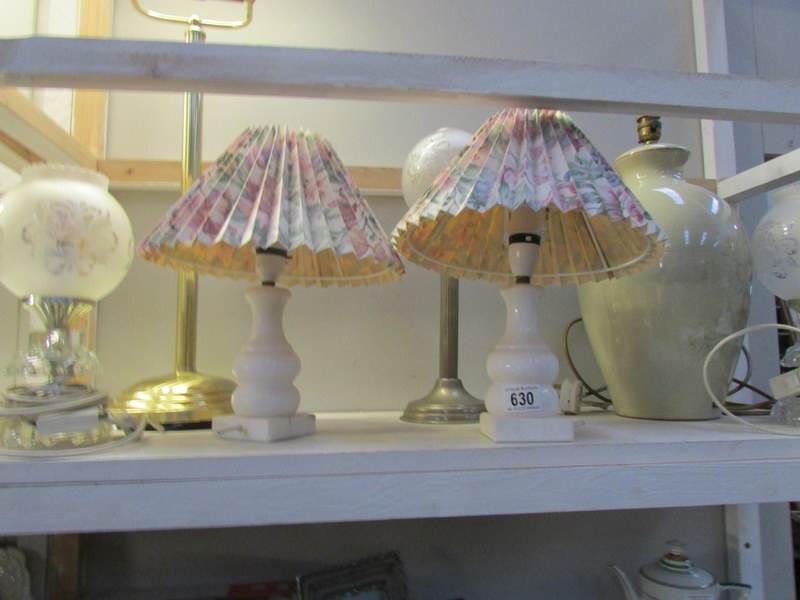 A shelf of table lamps